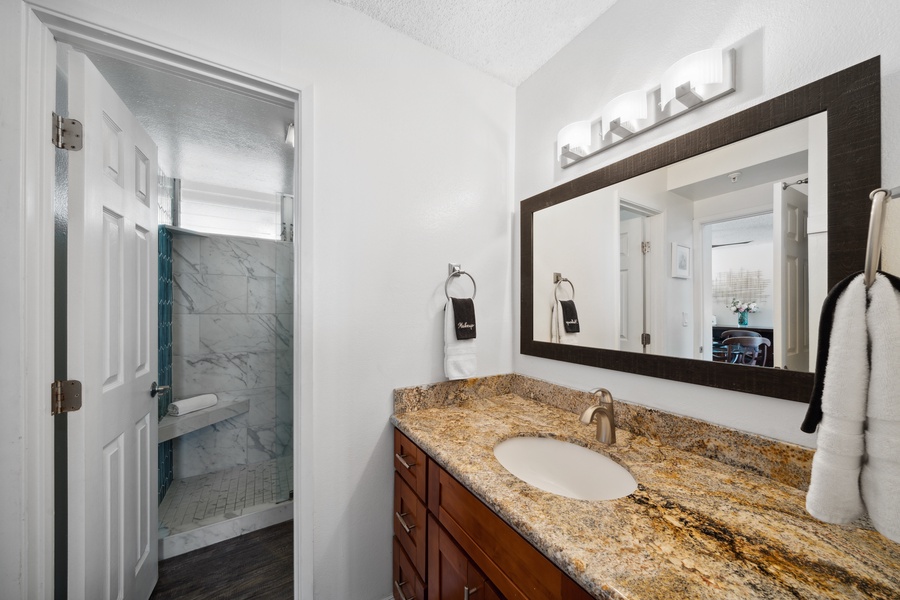 A sleek granite vanity and warm lighting give Royal Kahana 308’s bath a relaxing feel.