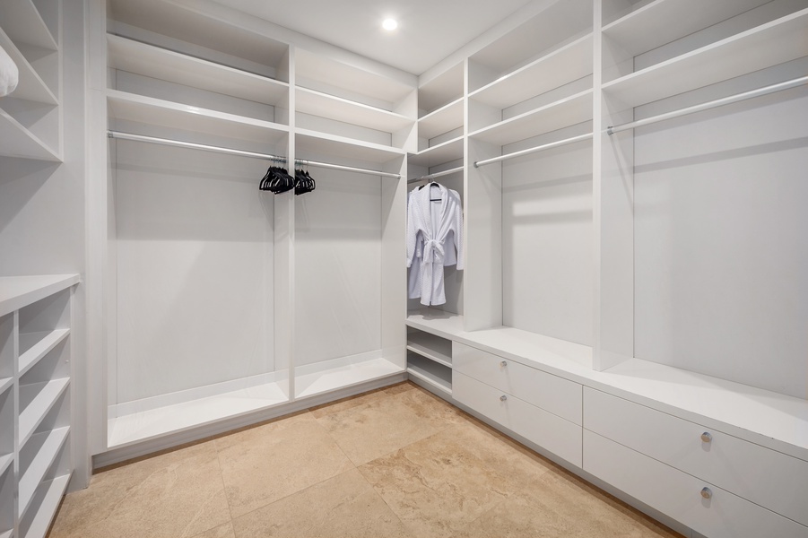 Spacious walk-in closet in the primary suite, featuring ample storage and a modern layout.