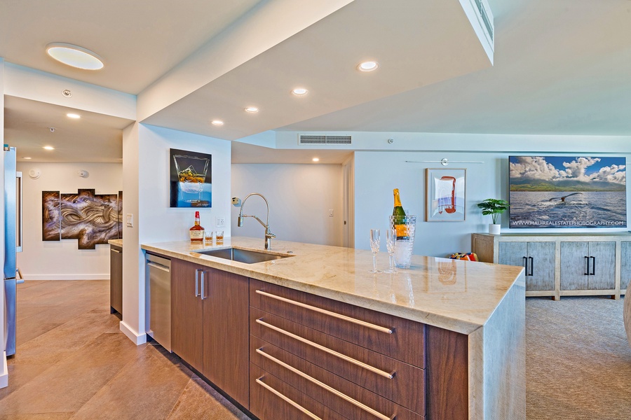 This modern kitchen island provides plenty of counter space, perfect for preparing meals or enjoying drinks with friends.