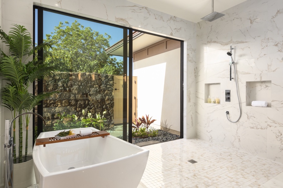Garden views for a relaxing soak in the ensuite bathroom also features rain shower and outdoor access.