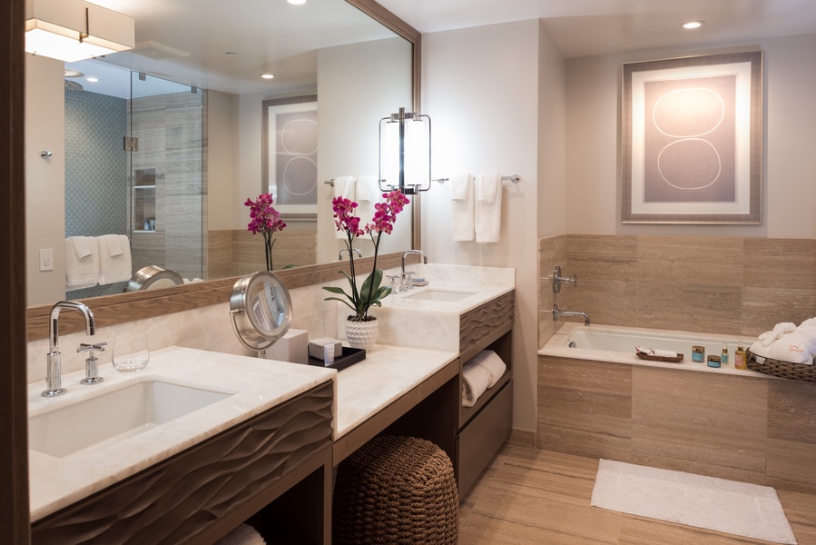 A second bathroom also offers a tub, a walk-in shower, and dual sinks.