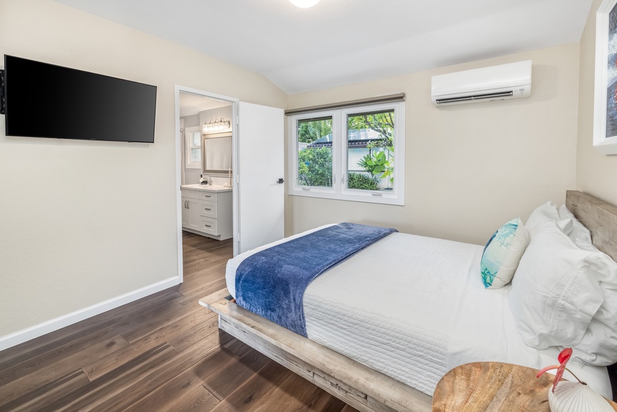 Comfortable suite offers a queen bed, split AC, TV with shared ensuite bathroom and garden views.