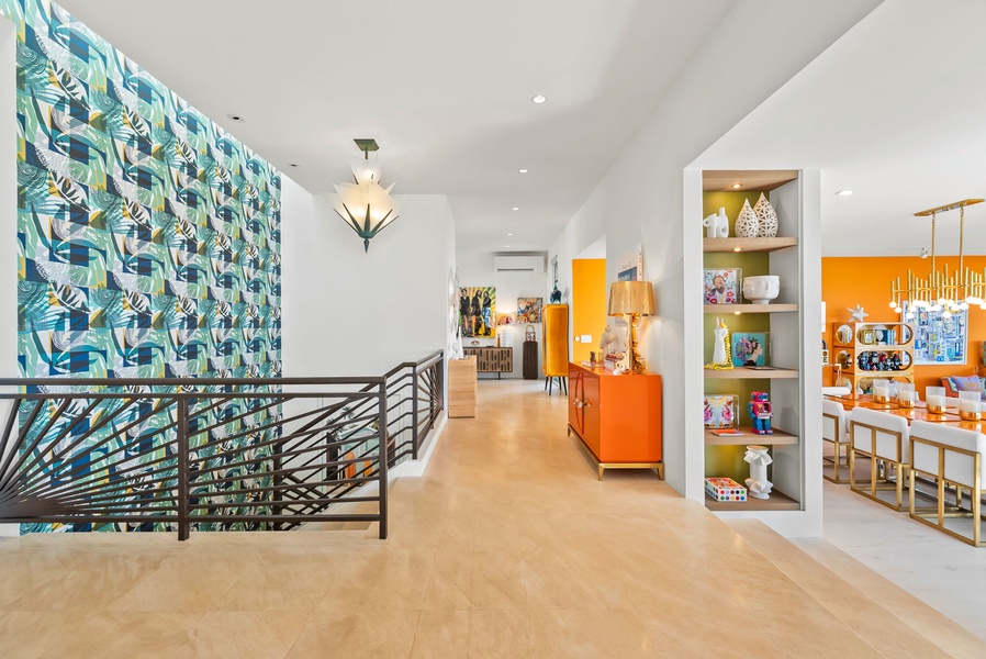 Spacious hallway with artistic wallpaper, bright natural light, and modern design touches.