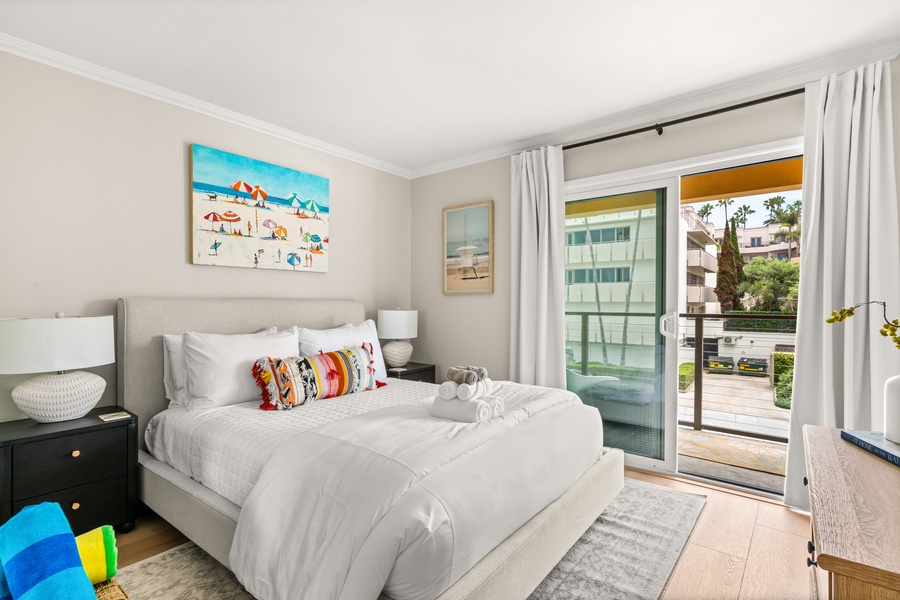 The guest bedroom with direct balcony access—enjoy fresh ocean air and morning sunshine.