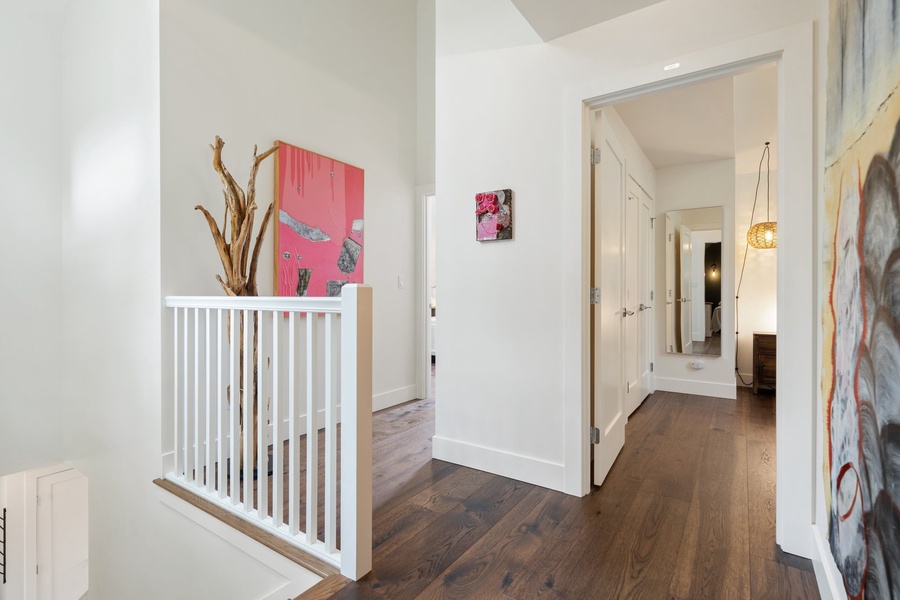 Colorful art and natural light welcome you from the upper landing.