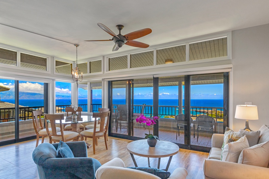 The bright, open-concept living and dining area is designed for relaxation and entertainment, with stunning floor-to-ceiling windows that offer panoramic ocean views.