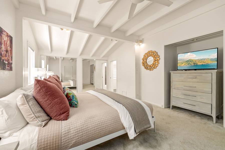 Sink into your spacious bedroom, where vaulted ceilings and soft natural light create an airy retreat. Cozy textured linens and charming coastal accents invite you to unwind completely.