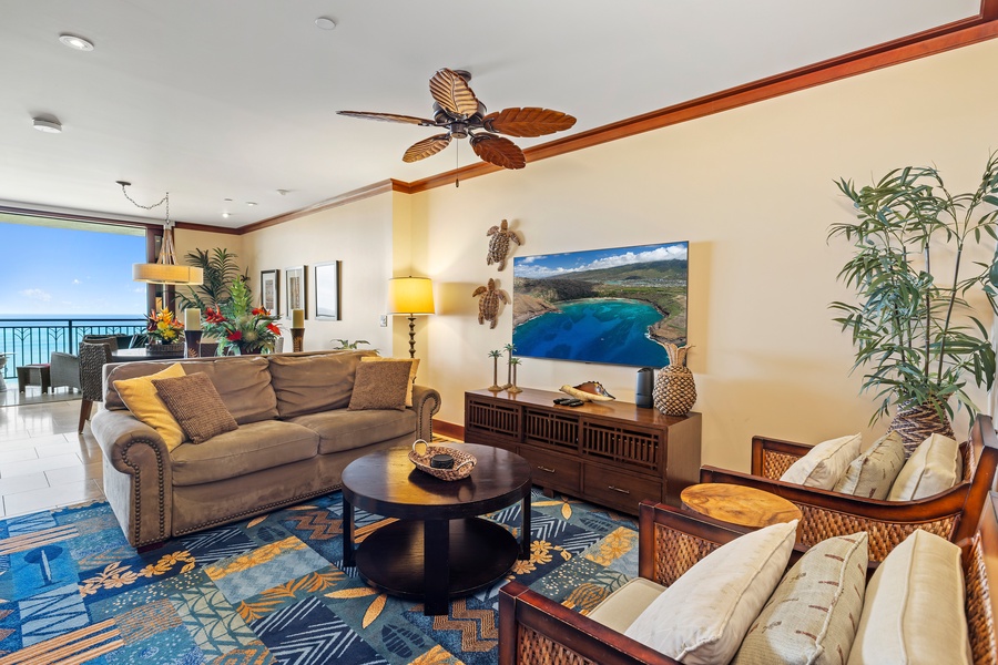 Sink into plush seating while ocean breezes flow through your tropical living space, complete with vibrant artwork and island-inspired décor.