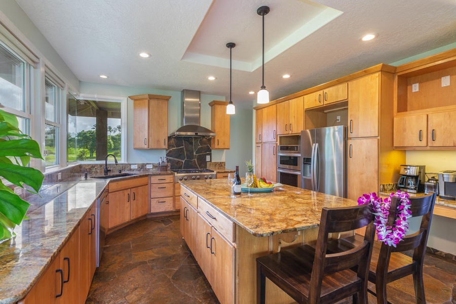 Pohaku Villa’s fully equipped kitchen with stainless steel appliances and warm wood cabinetry is ideal for group cooking.