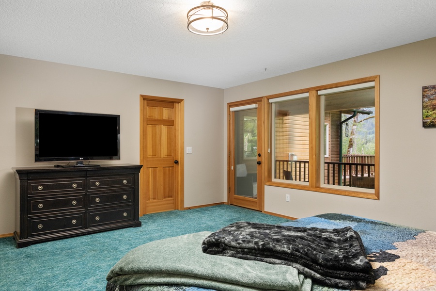 Main floor primary bedroom with access to private deck
