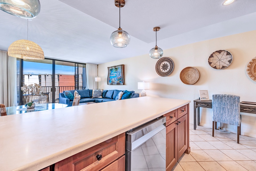 The kitchen island provides ample space for meal prep and doubles as a perfect spot for casual dining or conversation with those in the living room.