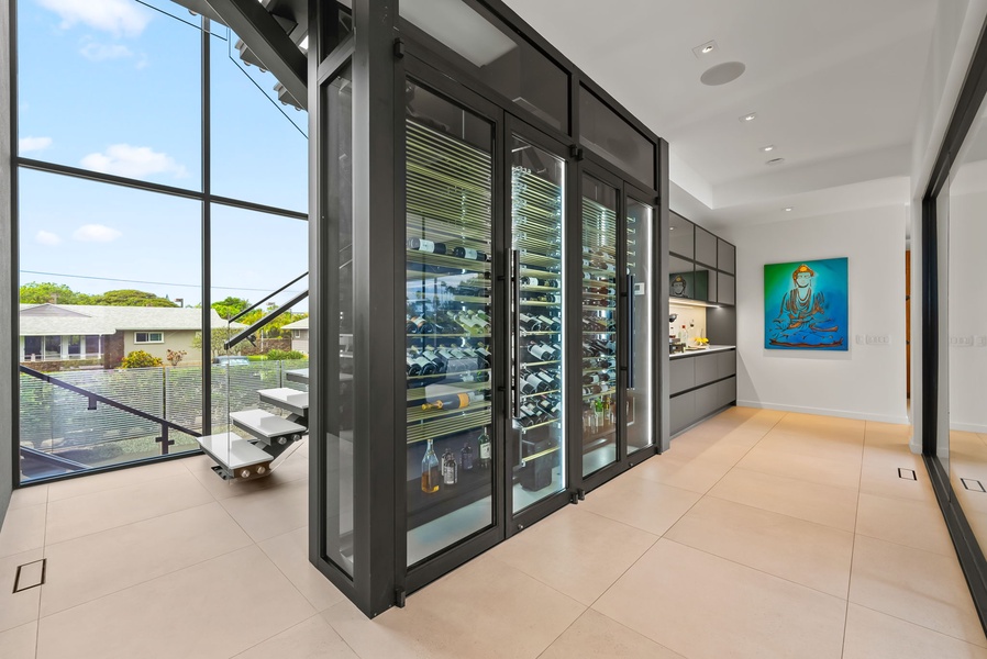 Curated and climate-controlled, this wine feature elevates the kitchen’s sleek, gallery-like atmosphere.