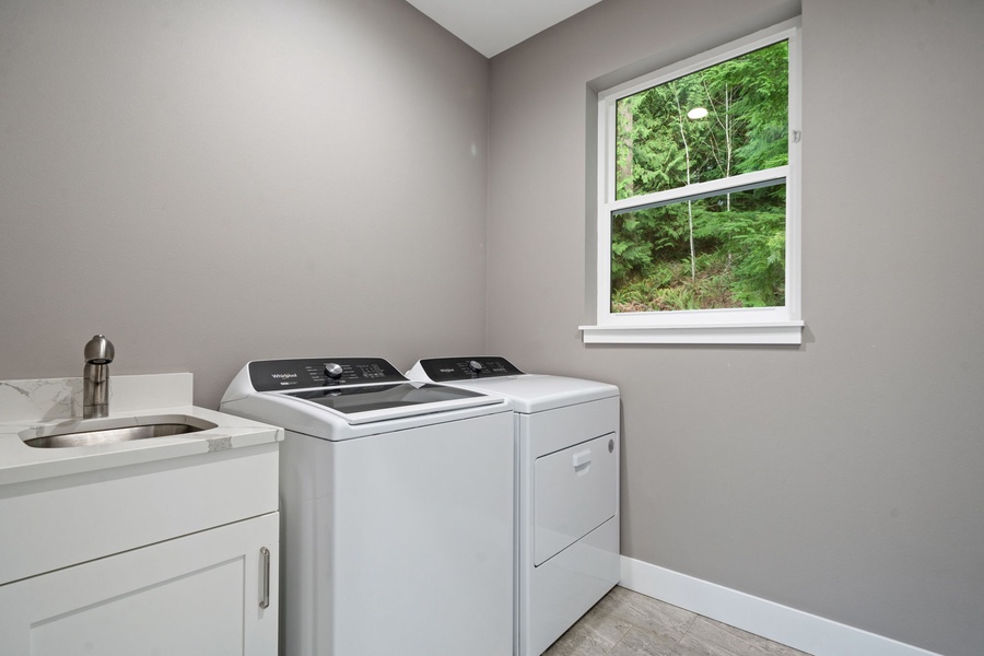 Your dedicated laundry room offers modern appliances and convenient countertop workspace, with peaceful garden views making chores feel effortless.