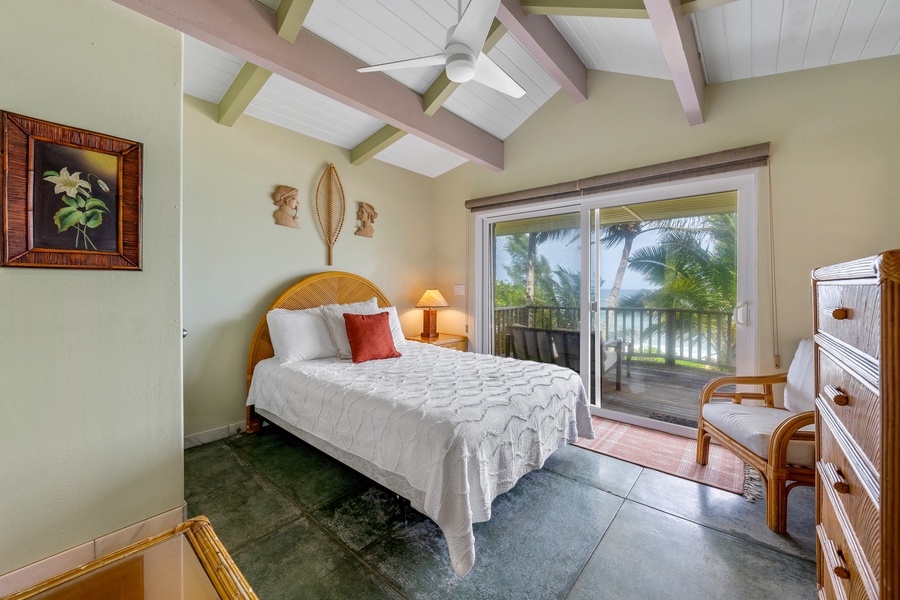 Relax in this bright bedroom with vaulted ceilings and step out to the private lanai to enjoy tropical views and fresh island air.