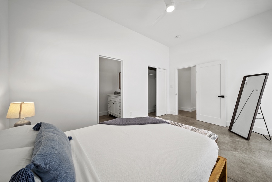 The guest suite downstairs features a plush queen-sized bed for a restful night.