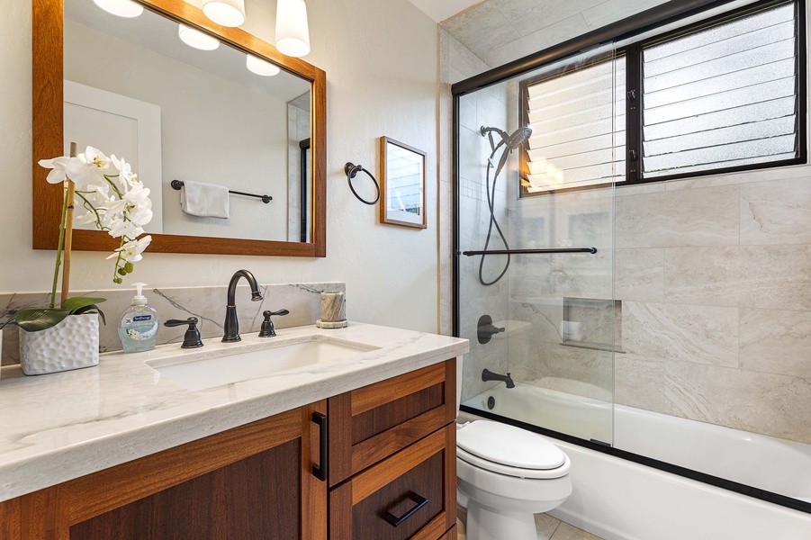 The full-size guest bathroom has been fully renovated, with a shower/tub combo and includes beautiful tile work throughout.