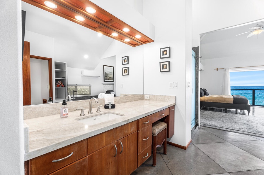 Primary ensuite bath with dual sinks, custom lighting, and a walk-in shower.