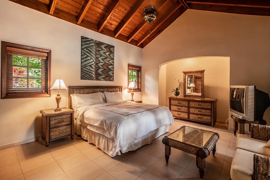 Comfortable bedroom in the guest house, featuring a vibrant decor and comfortable bed.