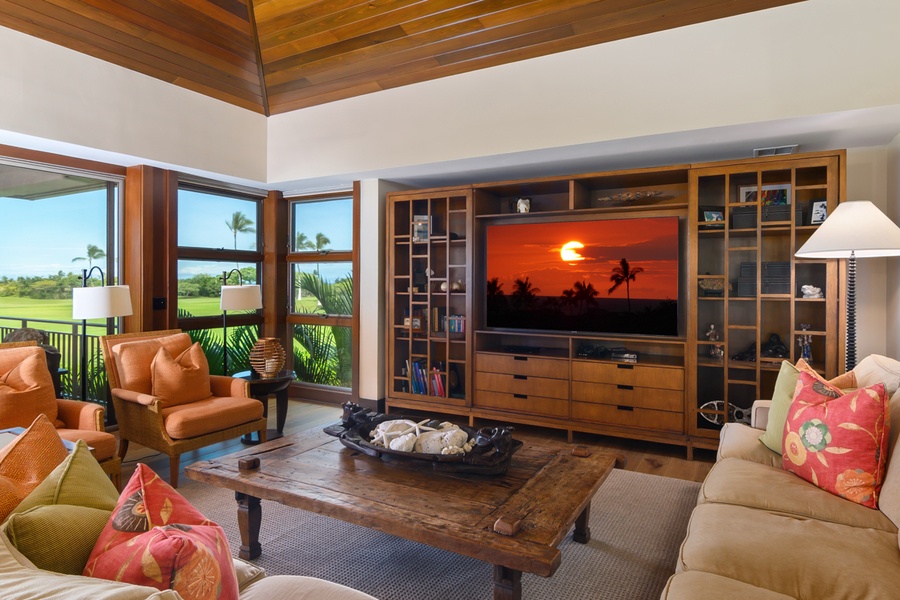 Unwind in your spacious living room with stunning tropical views, warm wood accents, and cozy seating perfect for relaxing evenings.