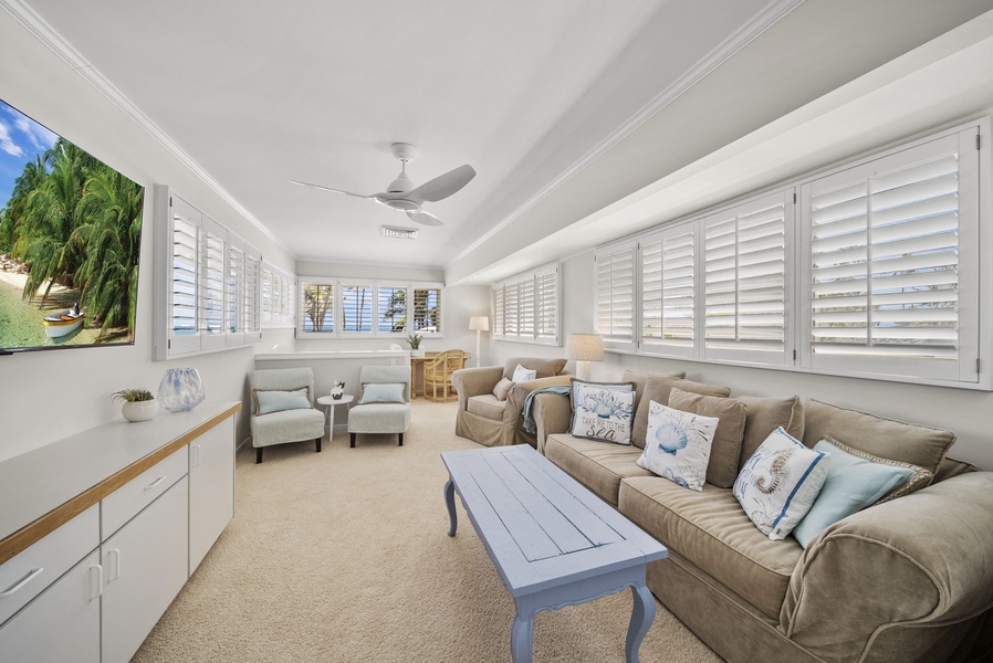 A comfortable lounge area with a TV for relaxing after a day of exploring Hawaii’s beaches and attractions.