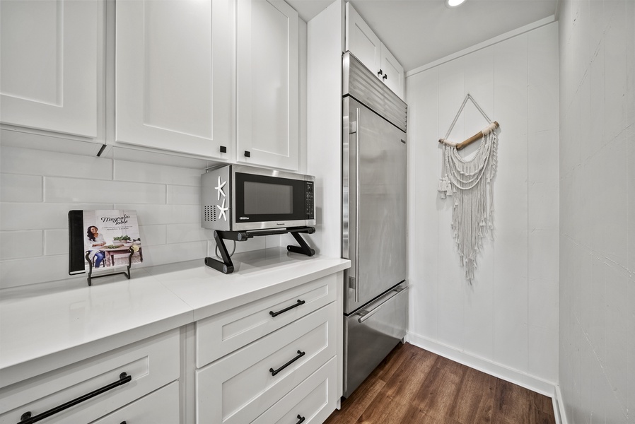 Convenient butler’s pantry and prep area with high-end appliances, offering everything needed for extended family stays or catered events.