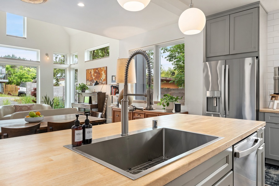 Chic design meets everyday comfort with a deep sink, open shelving, and coffee station essentials.