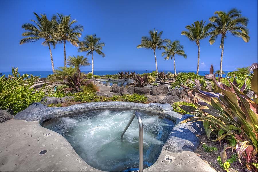Soak in the oceanfront jacuzzi while sipping on a Mai Tai