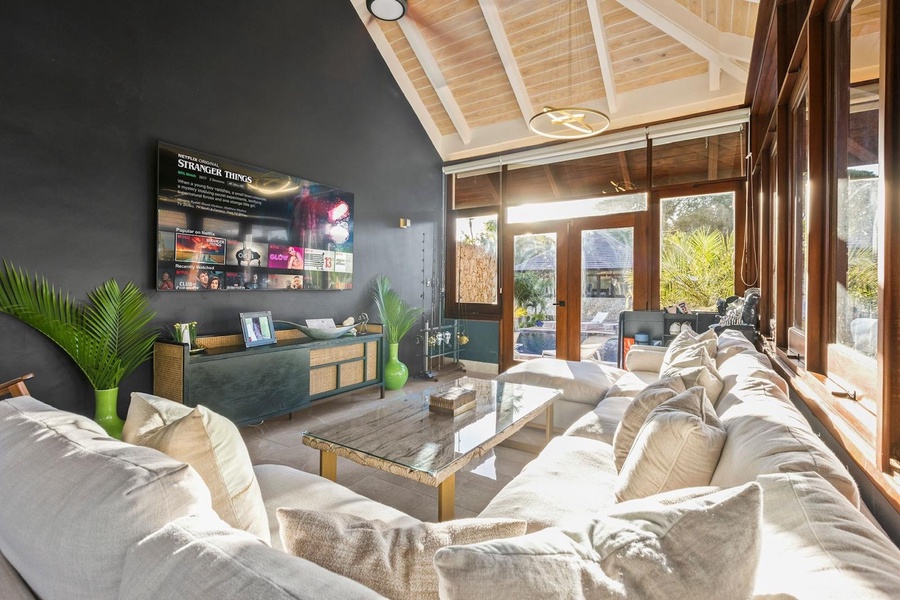 Bright and airy second living area featuring a large TV perfect for movie nights.
