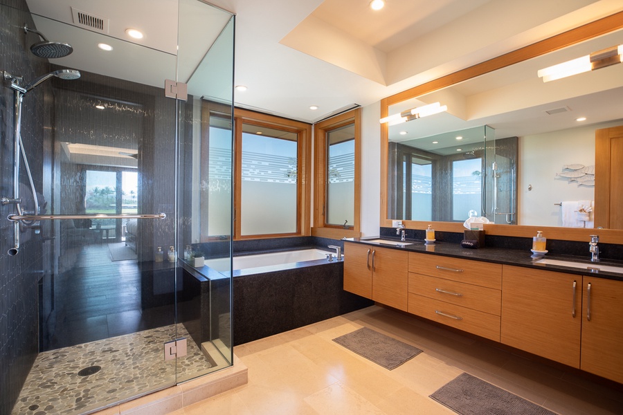 Huge vanity space beside the hot tub in the primary suite's ensuite bathroom
