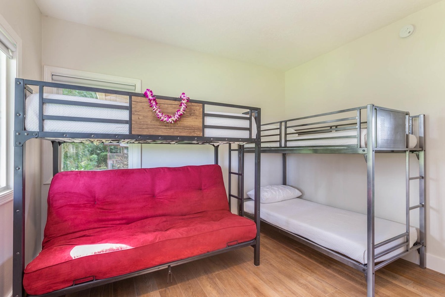 Family-friendly bunk room at Pohaku Villa with futon seating and twin-over-twin setup for kids or extra guests.