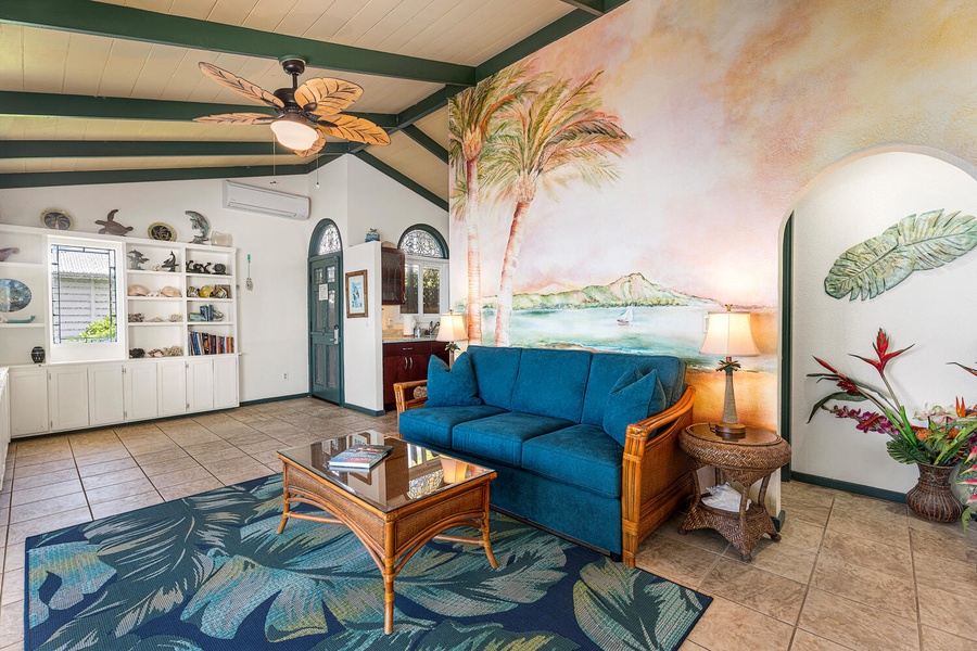 Featuring a queen sleeper sofa, ceiling fan, and colorful island-inspired décor for an authentic Hawaiian vibe.