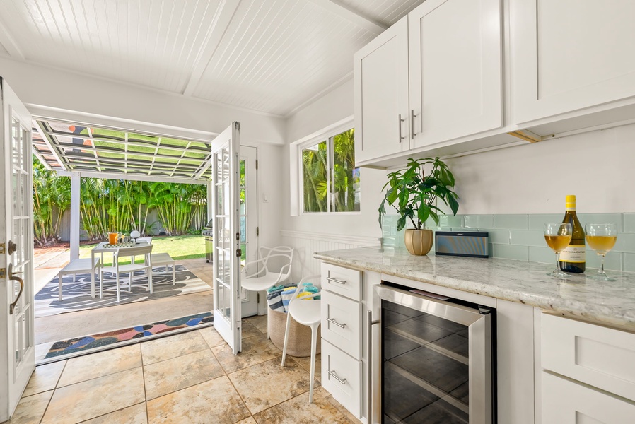 Bright, airy kitchen opens to your private patio, where morning coffee feels like a tropical escape. Clean lines, fresh finishes, and greenery framed in every window.