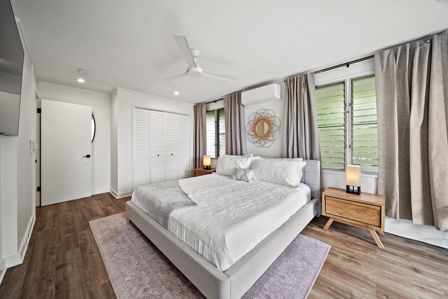 Airy bedroom with a king-sized bed, cozy textures, and serene garden views to create a restful retreat.