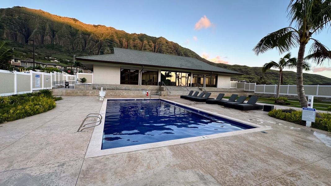 Cool off after beach adventures in the community pool with lounge chairs and mountain views.