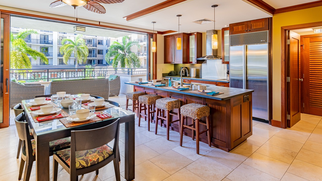 The kitchen with stainless steel appliances and island breezes from the lanai.