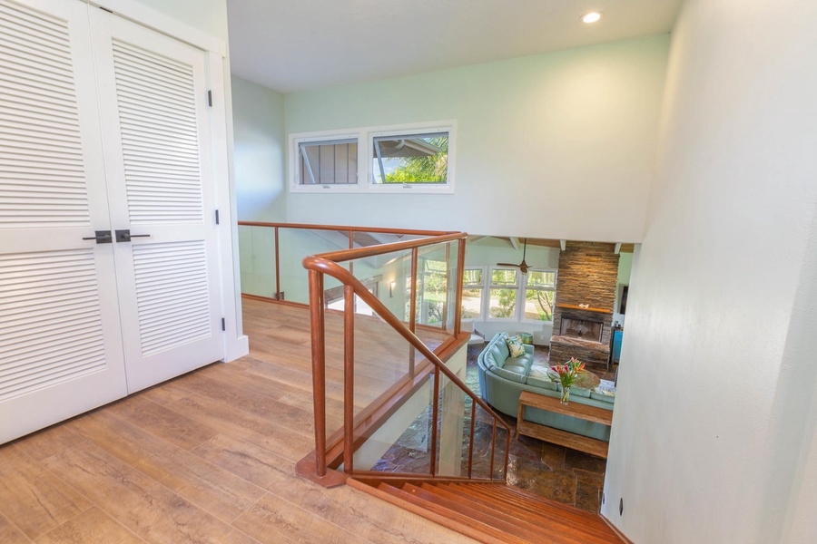 The upstairs landing at Pohaku Villa provides natural light and an airy transition to the upper bedrooms.