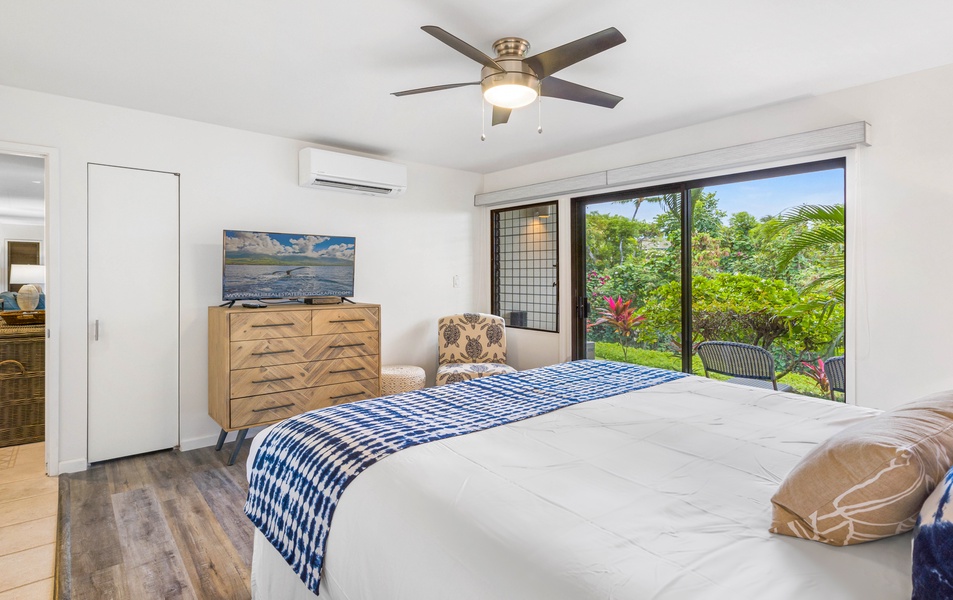 Wailea Ekolu 1605 bedroom offers easy garden access and lush greenery views, creating a peaceful retreat.