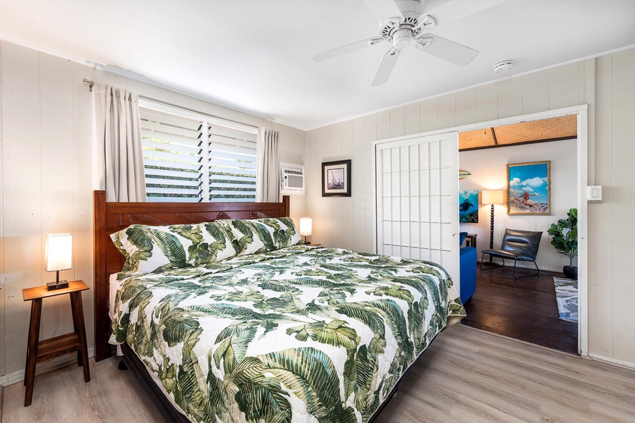 Additional guest room with a king bed and windows that welcome the ocean breeze.