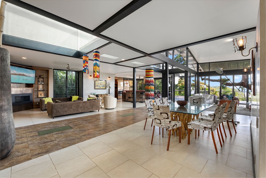 A chic dining area with modern furnishings, bathed in natural light from the outdoors.