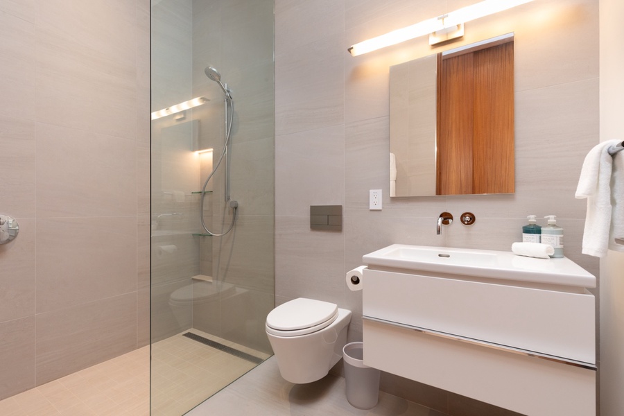 Sleek and modern bathroom 3 featuring a glass shower and subtle wood accents