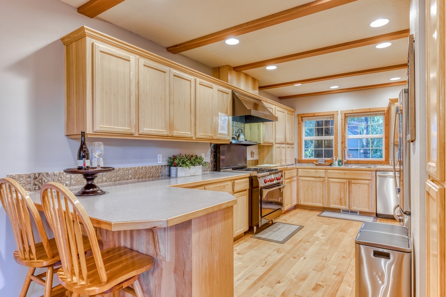 Enjoy casual dining or morning coffee at the kitchen counter, featuring comfortable seating.
