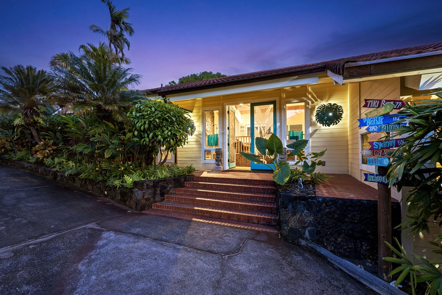 Step into a softly lit entrance, where tropical greenery frames your arrival.