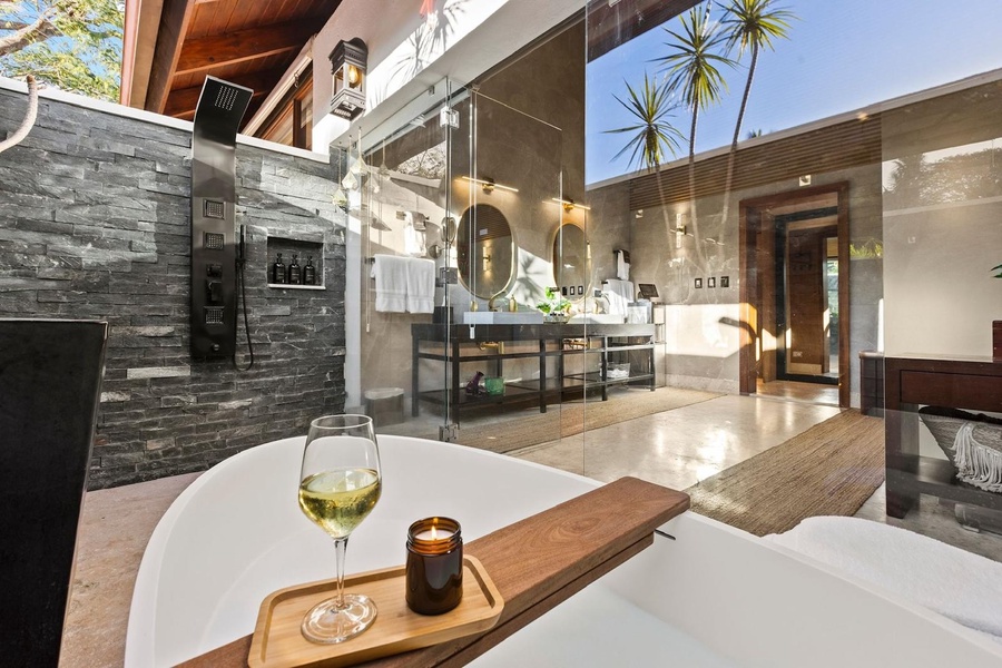 Relax in the modern ensuite bathroom complemented by a sleek stone accent wall.