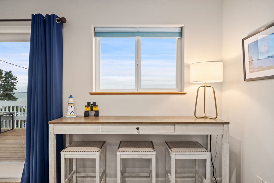 Your coastal workspace awaits with a charming nautical desk perfect for planning adventures or catching up on emails while enjoying sea breezes.