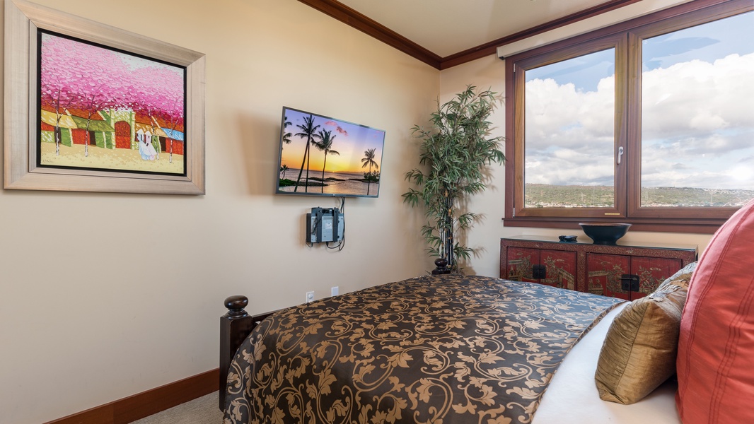 The second guest bedroom with a Queen bed, TV and island views.
