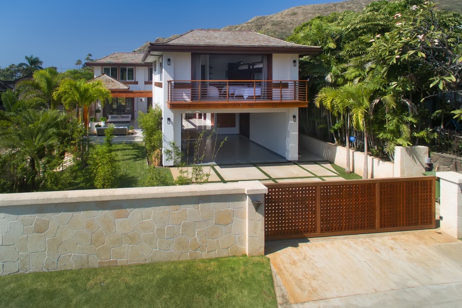 Gated front exterior offers both curb appeal and privacy in an exclusive beachfront enclave.