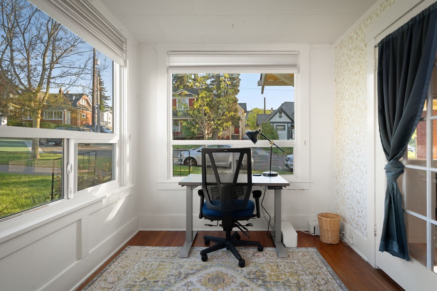 Focus comfortably in the sunny workspace with natural light and quiet surroundings.