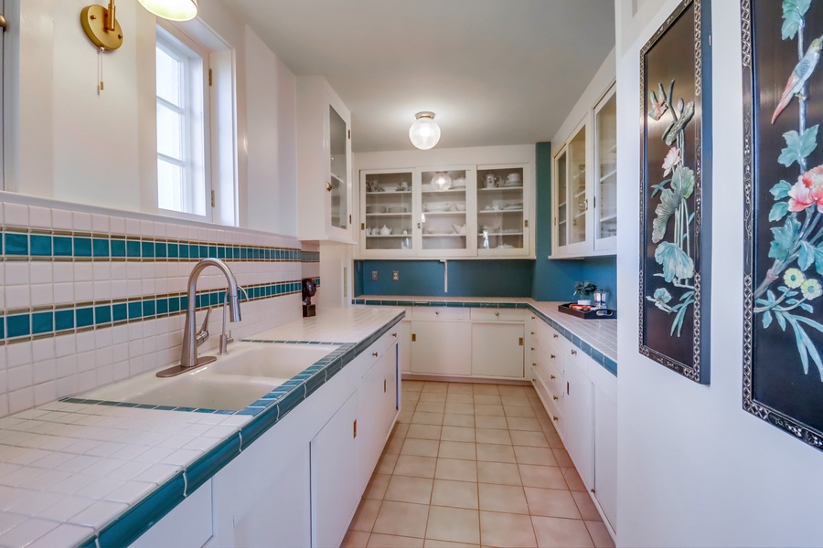 Step into the charming Butler's pantry, where vintage-inspired tile work and abundant cabinetry create a beautifully functional space for seamless meal preparation and elegant entertaining.