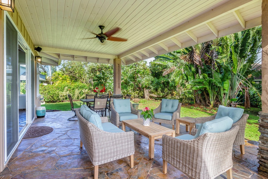 Enjoy shaded comfort at Pohaku Villa’s outdoor lounge, set against a lush tropical backdrop for gatherings any time of day.