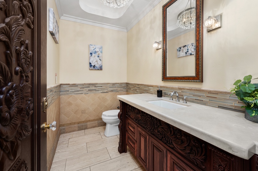 Framed in dark carved wood, the ensuite bathroom has its own alcove.